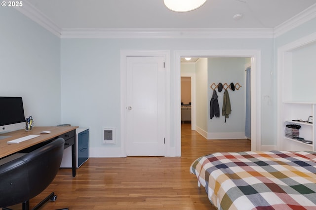 1811 NW Couch St Unit 210, Portland, OR 97209 - bedroom with crown molding, light wood-style floors, and a desk