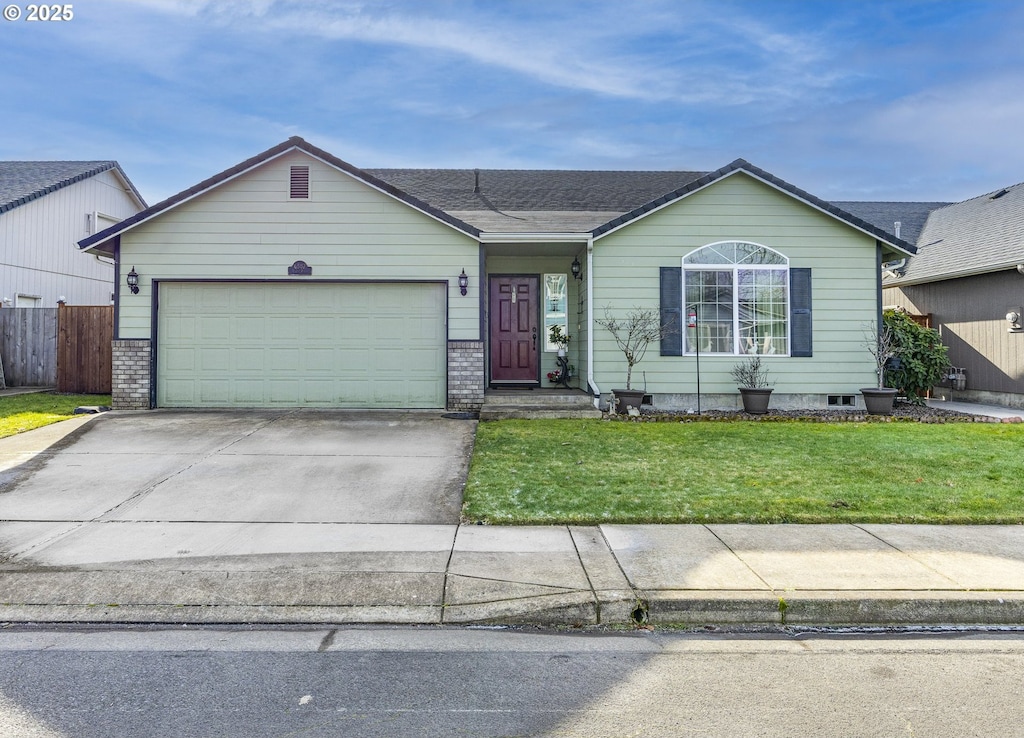 ranch-style home with a garage and a front yard