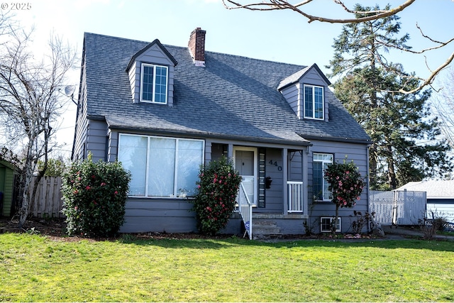 cape cod home with a front lawn, a chimney, a shingled roof, and fence