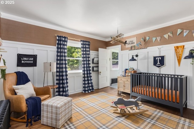 11175 S Riverwood Rd, Portland, OR 97219 - bedroom with a decorative wall, wood finished floors, crown molding, and wainscoting