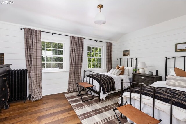 11175 S Riverwood Rd, Portland, OR 97219 - bedroom featuring radiator, hardwood / wood-style flooring, lofted ceiling, and wood walls