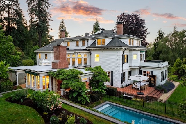 11175 S Riverwood Rd, Portland, OR 97219 - back of property at dusk with a wooden deck and a chimney
