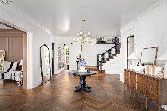11175 S Riverwood Rd, Portland, OR 97219 - entryway featuring a chandelier, stairs, ornamental molding, and arched walkways