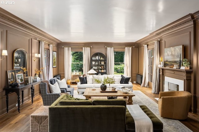 11175 S Riverwood Rd, Portland, OR 97219 - living room with crown molding, light wood finished floors, a decorative wall, and a fireplace with flush hearth