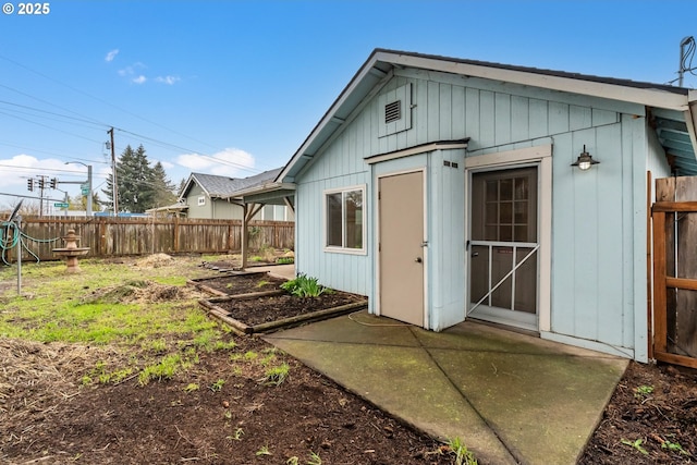 view of outbuilding featuring fence