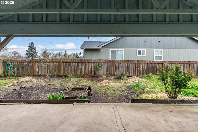 view of yard featuring a vegetable garden and a fenced backyard