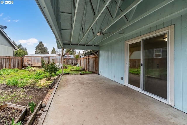 view of patio with a carport and a fenced backyard