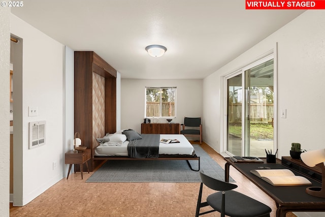 bedroom with baseboards, multiple windows, and access to outside