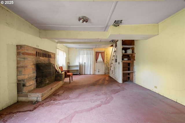 unfurnished living room featuring a fireplace with raised hearth and carpet flooring