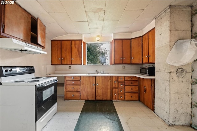 kitchen with under cabinet range hood, light countertops, electric range oven, light floors, and stainless steel microwave