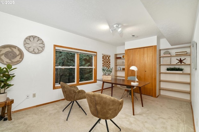 office space with baseboards, light colored carpet, and visible vents