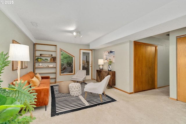 sitting room featuring baseboards and carpet