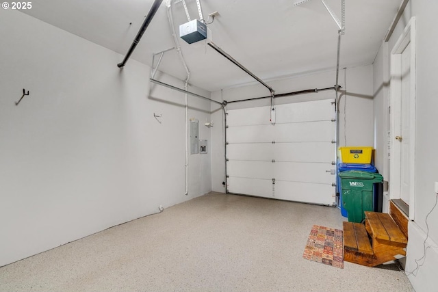 garage with a garage door opener and electric panel