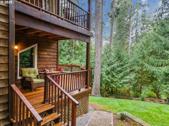 wooden deck featuring a yard