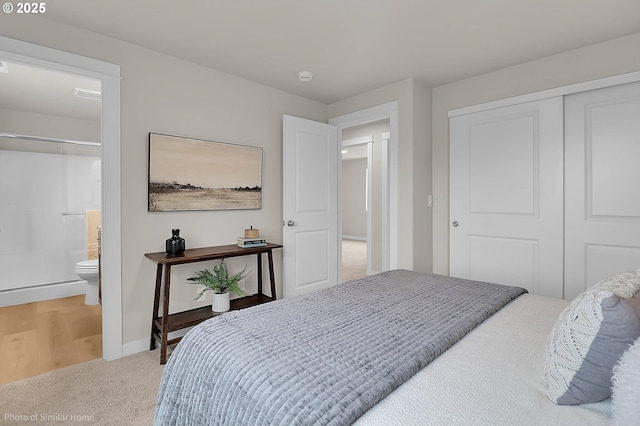 1021 Sommerville Loop, Harrisburg, OR 97446 - bedroom featuring light carpet, a closet, baseboards, and connected bathroom