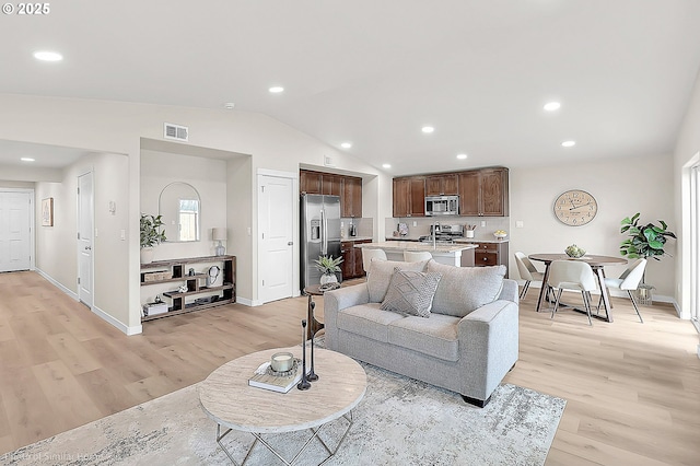 1021 Sommerville Loop, Harrisburg, OR 97446 - living room with light wood-type flooring, baseboards, lofted ceiling, and recessed lighting