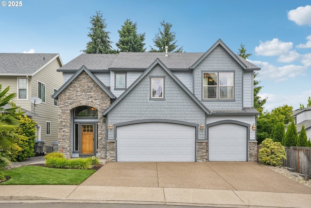 17141 SW King Richard Ct, Sherwood, OR 97140 - craftsman inspired home featuring stone siding, a garage, driveway, and a shingled roof