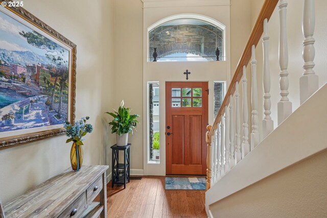 17141 SW King Richard Ct, Sherwood, OR 97140 - foyer featuring light wood finished floors, a high ceiling, and stairway