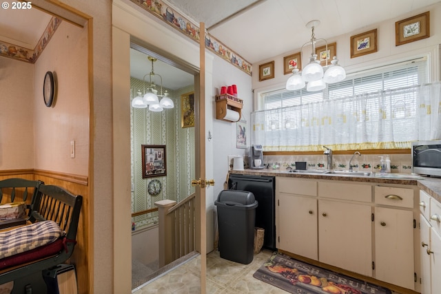 860 Adams St, Eugene, OR 97402 - kitchen featuring a chandelier, a sink, stainless steel microwave, and white cabinetry