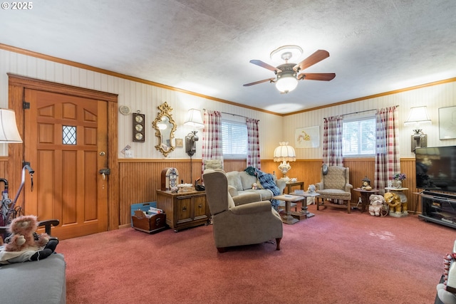 860 Adams St, Eugene, OR 97402 - carpeted living room featuring plenty of natural light, ornamental molding, wooden walls, ceiling fan, and a wainscoted wall