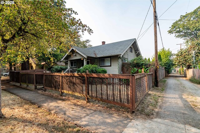 860 Adams St, Eugene, OR 97402 - bungalow-style house featuring a fenced front yard, a chimney, and driveway