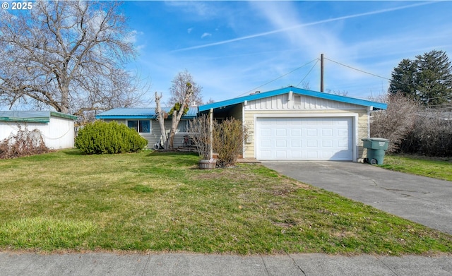 view of front of house featuring driveway, a front yard, and an attached garage