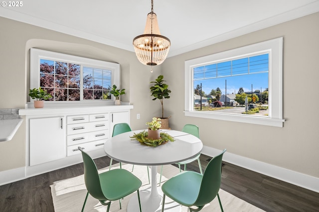 6959 N Denver Ave, Portland, OR 97217 - dining room with dark wood-type flooring, a chandelier, and baseboards