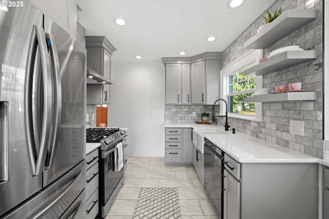 6959 N Denver Ave, Portland, OR 97217 - kitchen with freestanding refrigerator, gray cabinets, gas stove, a sink, and recessed lighting
