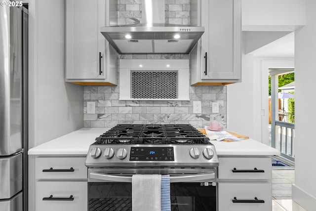 6959 N Denver Ave, Portland, OR 97217 - kitchen featuring appliances with stainless steel finishes, wall chimney range hood, tasteful backsplash, and light countertops