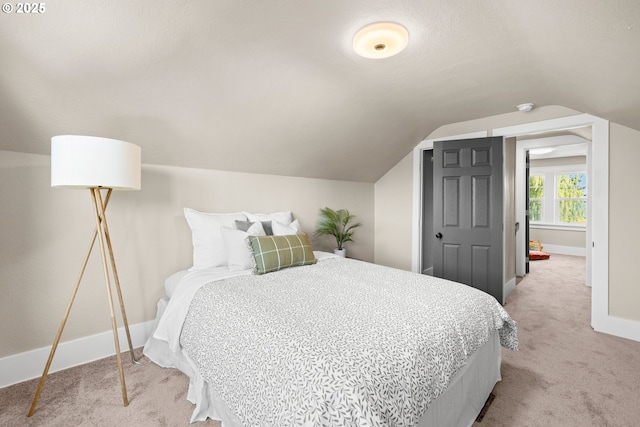6959 N Denver Ave, Portland, OR 97217 - bedroom with light colored carpet, baseboards, and lofted ceiling