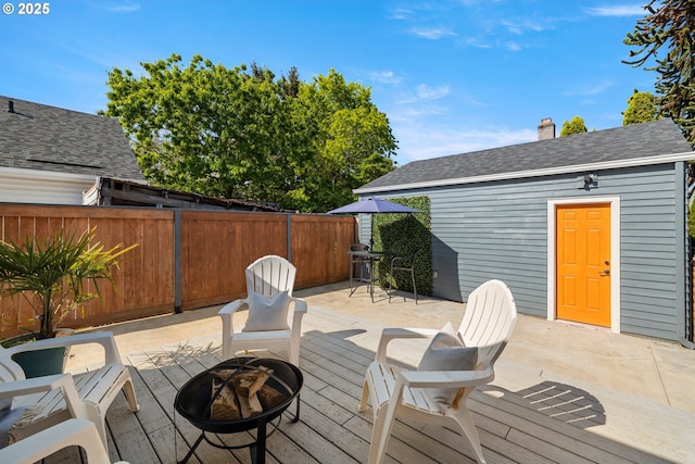 6959 N Denver Ave, Portland, OR 97217 - wooden terrace with a fire pit, fence, and area for grilling