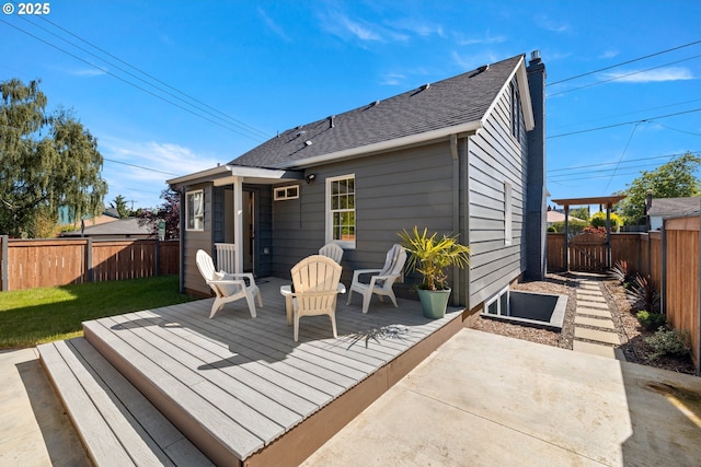 6959 N Denver Ave, Portland, OR 97217 - back of house with a fenced backyard, a wooden deck, and a shingled roof