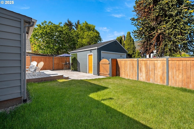 6959 N Denver Ave, Portland, OR 97217 - view of yard featuring a shed, a detached garage, an outbuilding, and a deck