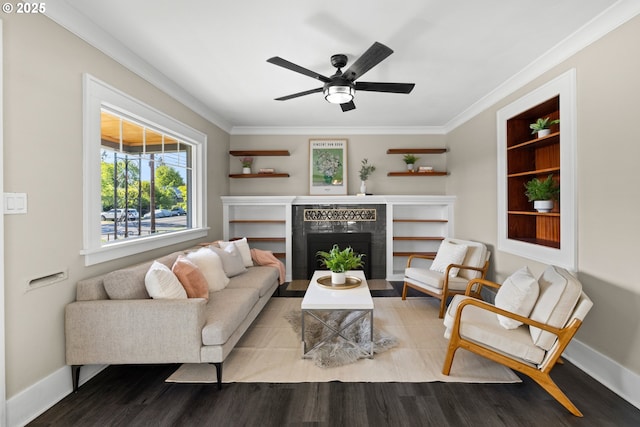 6959 N Denver Ave, Portland, OR 97217 - living room featuring wood finished floors, ornamental molding, ceiling fan, a tile fireplace, and baseboards