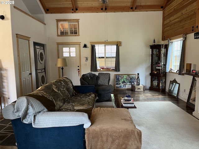 34376 State Highway 38, Scottsburg, OR 97473 - living area with stacked washer and clothes dryer, wooden ceiling with exposed beams, high vaulted ceiling, and wood finished floors