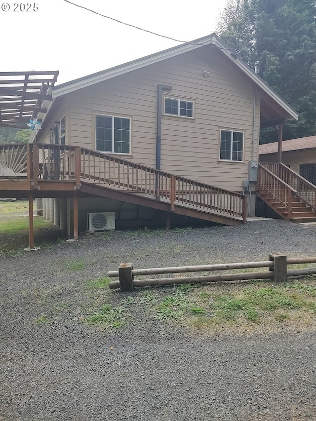 34376 State Highway 38, Scottsburg, OR 97473 - rear view of house with a wooden deck, a cooling unit, and stairs