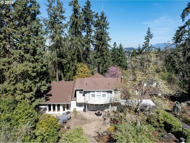aerial view of property and surrounding area with a forest