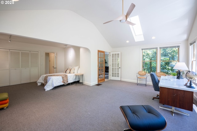 bedroom with a skylight, carpet flooring, french doors, baseboards, and an office area