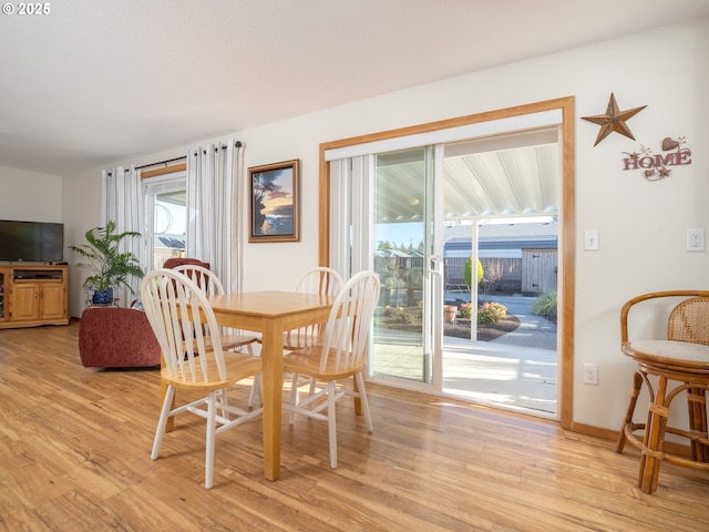 dining space with light hardwood / wood-style floors