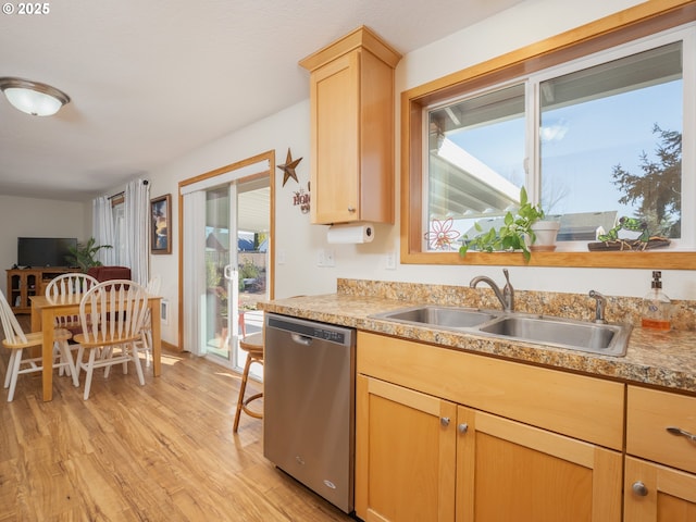 kitchen featuring light brown cabinetry, sink, dishwasher, and light wood-type flooring