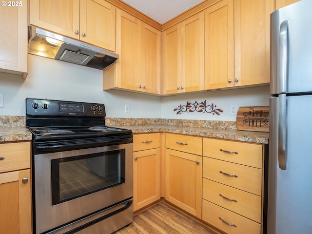 kitchen featuring stainless steel appliances, light stone countertops, light brown cabinetry, and light hardwood / wood-style floors