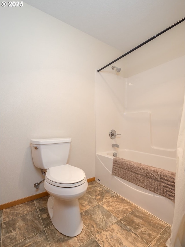 bathroom with shower / tub combination and toilet