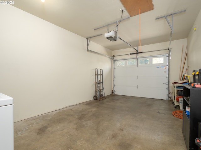 garage with a garage door opener and washer / dryer