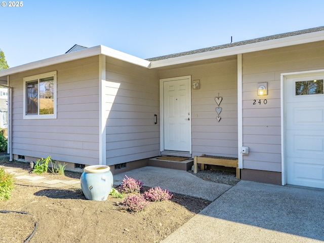 view of exterior entry with a garage