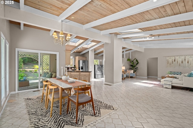 dining room with independent washer and dryer, a chandelier, plenty of natural light, baseboards, and wooden ceiling