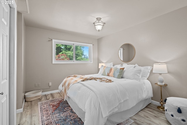 bedroom featuring baseboards and light wood-type flooring