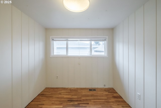 spare room featuring light wood-style flooring and visible vents