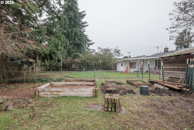 view of yard with a vegetable garden and fence