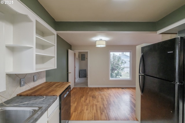 kitchen featuring butcher block counters, light wood-style flooring, black appliances, white cabinetry, and open shelves