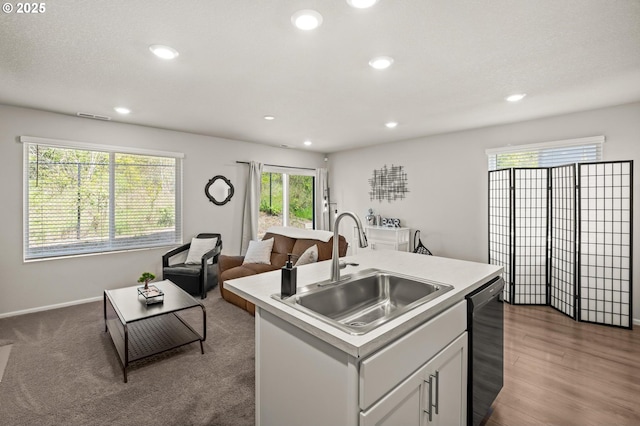 kitchen with recessed lighting, light countertops, dishwasher, visible vents, and a sink
